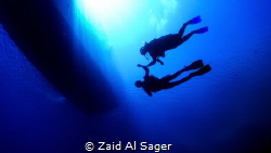 Swimming under the boat on a nice, sunny day. by Zaid Al Sager 